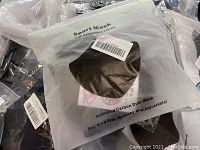Photo showing packaged Sport Mask with exhalation valve and activated carbon dust filter, standard size, stretchy and adjustable.