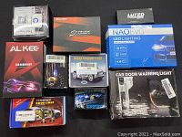 Photo showing all boxes of LED car headlights and car lighting accessories arranged on a flat surface.