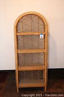 Front view of arched shelf cabinet showing all four shelves