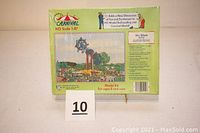 Photo of the sealed model kit box for the HO Scale Carnival 5112 Skywheel, showing front and top with colorful design and text indicating scale and series.