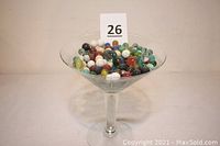 Large oversized martini glass filled with many colorful vintage marbles of various sizes and styles.