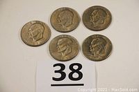 Five Eisenhower half dollar coins, four dated 1971 and one 1972D, arranged on a white background with a number card below.