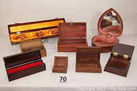 View of eight assorted wooden boxes of various sizes and finishes including mini Lane cedar chest, heart-shaped velvet-lined jewelry box with mirror, and other small wooden keepsake boxes.