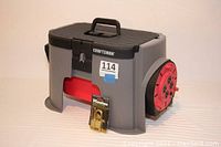 Craftsman Handy Step Tool Box with red detachable 20 ft cord reel and 4 power outlets, black latch, and carrying handle on top.