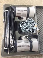 Open case showing two flash heads, umbrella and cables