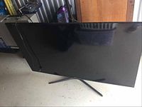 Front view showing 55" LED screen and Y-style stand