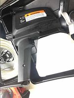 Close-up of the Wagner spray gun with attached white container inside the black carrying case.