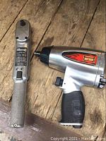 Photo of Hot Rod air impact wrench and Skil Wrench on a wooden surface