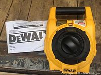 DeWalt rotary laser level body and instruction manual laid flat on a work surface