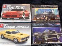 Four vintage model car kits with original box art including Dodge Viper RT/10, 1969 Cougar Eliminator, Buick Grand National, and '65 Vette Street Machine, showing box conditions including sealed and unsealed boxes.