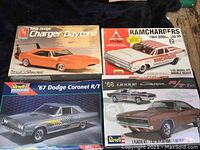 Four vintage Dodge model car kits displayed with visible box art and titles showing the makes and models.