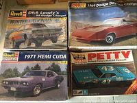 Four unopened model kit boxes arranged in two rows showing all lot contents.