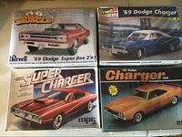 Four vintage 1969 Dodge muscle car model kits in original boxes, showing front cover artwork and arranged in a grid.