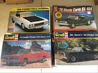 Four vintage model car kits in original boxes including '69 Ford Talladega, '70 Monte Carlo SS 454, '67 Dodge Charger, and Mr. Norm's '68 Dodge Dart.
