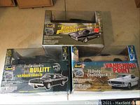 Three boxed Revell metal body car kits showing original packaging and condition.
