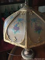 Close-up of painted glass shade panel with pink roses and blue ribbon