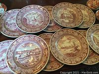 Stacked maroon transferware plates on table