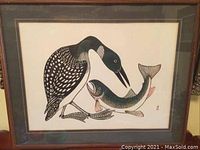 Front photo of framed artwork showing a loon bird holding a fish against a white background, framed in dark wood or composite frame.