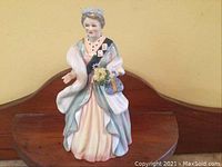 Front view of the figurine showing full gown, wrap and facial details