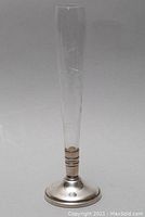 Full view of the crystal bud vase with etched floral pattern and silver base.