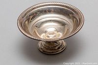 Front angle view showing bowl shape, rope border and inner surface