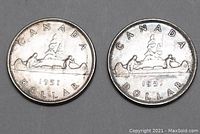 Pair of 1951 Canadian silver dollar coins showing the canoe design side
