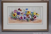 Full view of framed watercolour showing basket of colorful flowers.