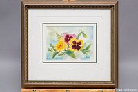 Full view of framed watercolour painting depicting pansy flowers and signed Pie Menger 1990.