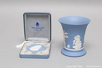 Wedgwood jasperware-style bud vase and Christmas Santa ornament in original box, ornament features white relief Santa on blue, vase has white relief designs with slight interior staining.