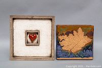 Photo showing both the signed wall art and the planter side by side against gray background.