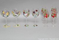 Full set showing 10 hand-painted glass stemware pieces with butterfly and strawberry motifs