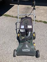 Front angled view of Yardworks LawnVac displaying intake and collection bag with labels.