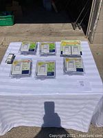 Seven Leviton motion sensor light switches in original packaging displayed on a white tablecloth, clearly showing the lot contents.