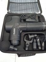 Muscle massage gun and accessories in carrying case showing device, attachments, and charger.