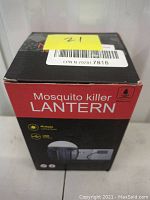 Front of the box showing product name 'Mosquito killer LANTERN' with features like multiple lighting modes and USB charging, rainproof.