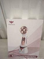 Front of the box showing Mismon multifunctional beauty device with four metal nodes on the head and control buttons on the handle.