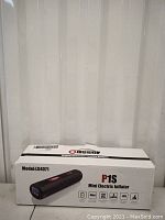 Photo of the product box showing the model H54071 and P1S Mini Electric Inflator branding with icons indicating features like digital, mini size, 120 psi, LCD, and 3 units.