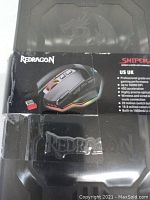 Photo of exterior packaging showing Redragon logo and Sniper Pro wired & wireless mouse with key features listed