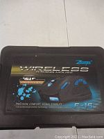 Closed carrying case box with product name Zelotes Wireless Gaming Mouse F-15 and branding; highlights 2.4G rechargeable wireless technology.