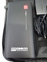 Close-up of Gooloo Elite Series jump starter power bank showing front with red power button and LED indicators.