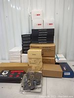 Overview of all batteries and chargers stacked in boxes, showing variety and quantity