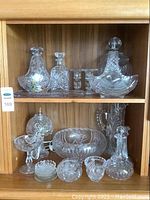 Overall view of top and bottom shelves showing all crystal pieces