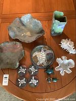 Overview photo showing all items including two large metal bowls, sea turtle plate and coasters, vase, coral sculptures, and turtle figurines.