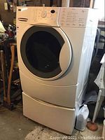 Front view of washer on pedestal storage drawer showing overall condition