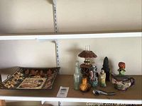Wide view of the lot with decorative mat, figurines, bottles, and other items