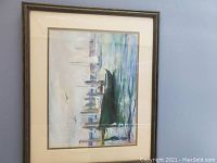Framed oil painting depicting boats on water with city skyline in background.