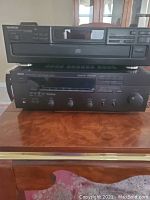 Front view of Yamaha RV-701 stereo receiver and Kenwood DPR-3060 multi-disc CD player stacked on a wooden surface.