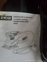 Operator's manual photo showing Ryobi 1/4 Sheet Sander model S652D, double insulated.