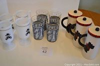 Photo showing all items including white Irish coffee mugs with bowling pin and ball design, blue Greek Roman patterned glasses, and the Scottie dog mugs with lids and tartan scarf design.