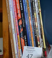 Photo of book spines showing titles and authors in a vertical row.